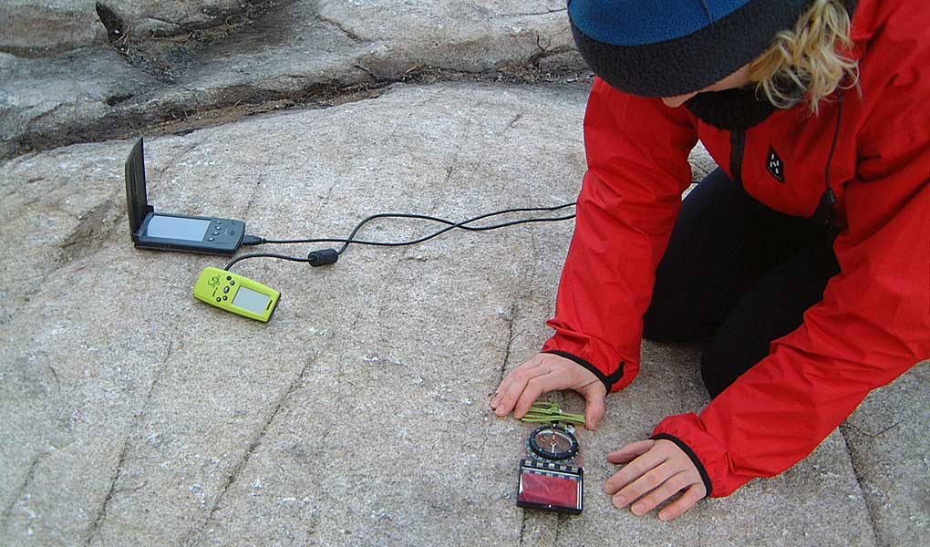 Recording fracture measurements using an early digital field mapping system in 2003, with hand-held GPS connected to a PDA.